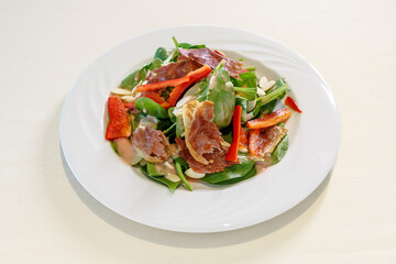 A plate of food with a salad on it