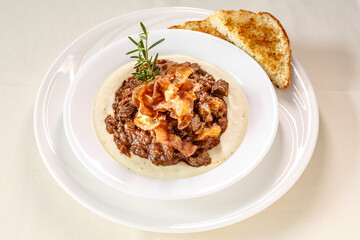 A plate of food with a piece of bread on the side