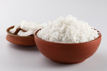 Desiccated coconut in terracotta bowl 