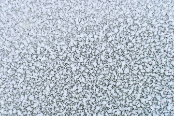 Macro view of intricate snow crystals shimmering in sunlight, showcasing natural frost patterns and winter textures in detail.