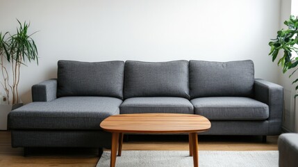 Obraz premium A gray couch with a wooden coffee table in the middle of the room