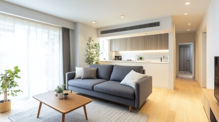 A living room with a couch, coffee table, and potted plant