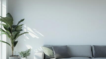 A white wall with a large plant and a gray couch