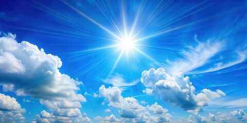 Serene blue summer sky with bright sun shining through a few wispy white clouds, atmosphere