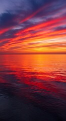 Obraz premium Vibrant Sunset Reflected in Tranquil Ocean Waters