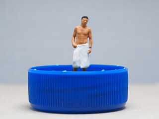 Mini toy of action figure with blurred background. Miniature photography concept design. Minifigure...