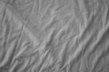 Naklejka premium Texture of Dark grey crumpled textile cloth part with small folds