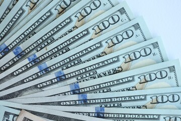 Many dollar bills with different nominations lies in big pile