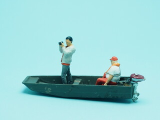 Mini toy of action figure at with blurred background. Toy photography concept design. A man with...