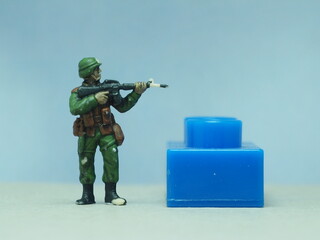 Mini toy of action figure at table with blurred background. Toy photography concept design....