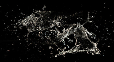 Crown water to object make curve drop explosion in ripple motion. Black background isolated. Crown Water splash on object to create shape form fluttering in droplet and wave.