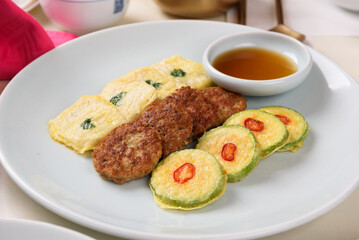 Pancakes made with fish, pumpkin, and meat, served with soy sauce