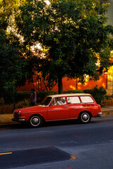 Fototapeta premium Red car parked on a red street in Oakland, california
