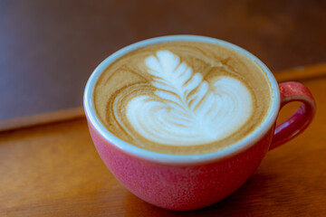 Barista concept, Purple pink coffee cup on the table, Hot cappuccino or latte art with milk foam on the top, Drinking coffee at the cafe' in the afternoon, Beverage background.