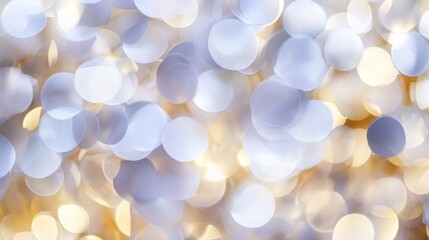 Abstract bokeh background with soft, glowing lights in white and gold.