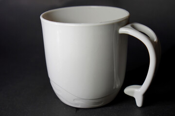 Minimalist Mug Design: A white mug with a textured base and ergonomic handle, captured in a clean, modern style.