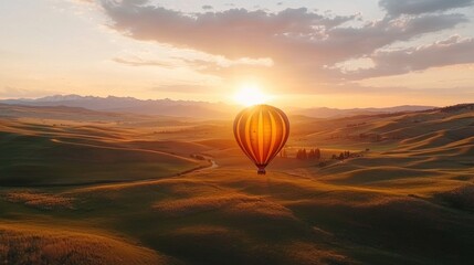 Obraz premium Breathtaking Sunset Over Majestic Countryside with Floating Hot Air Balloon in Peaceful Solitude