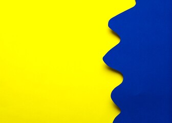 Blue and yellow paper background with copy space for text or image.