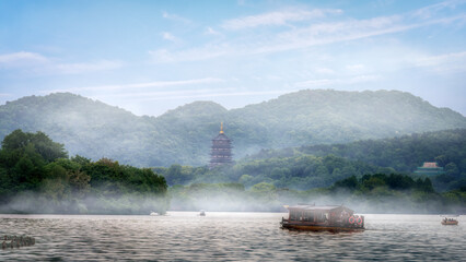 Tranquil Lake Scene with Misty Mountains and Pagoda