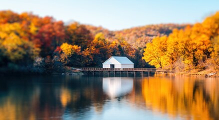 Fototapeta premium Serene Autumn Landscape with White House by Calm Reflections Lake