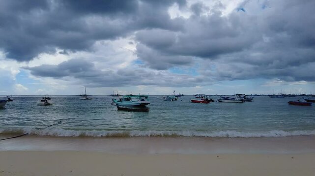 a collection of fishing boats anchored on the beach