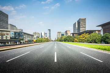 Expansive City Road with Modern Architecture Under Clear Sky