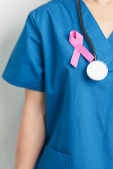 Pink October Breast Cancer Awareness month, woman doctor with pink Ribbon in hospital for support...