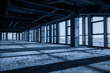 Urban Abandonment: A Blue-toned Empty Industrial Space with Shadows