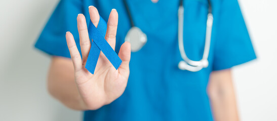 March Colorectal Cancer Awareness month, doctor with dark Blue Ribbon for supporting people living...
