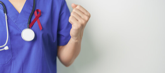 Doctor with Burgundy Red Ribbon for March multiple myeloma Cancer and December World Aids Day...