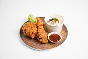 Deliciously crispy fried chicken served with fragrant rice and savory sides isolated on white background