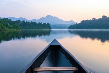 Obraz premium Serene Morning at Lake with Boat and Mountains in the Background