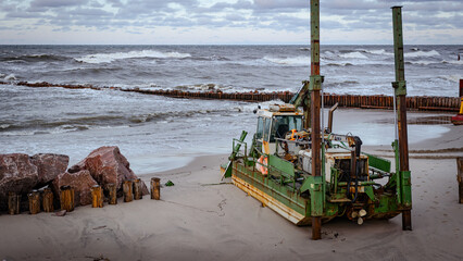 Dredger on the Beach Working to Clean and Deepen the Ocean Floor During Challenging Wave Conditions