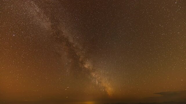 The Milky Way is bright and clear in the dark sky on Doi Chik Chong in Mae Hong Son Thailand. It is a remote place with beautiful nature and fresh air.The Milky Way orbits over a steep mountain range