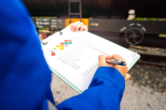 Checking on chemical hazard material checklist, for the crude oil transportation by railway logistic. Industrial safety working practice concept, close-up. 