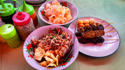 selective focus on chicken porridge and offal satay