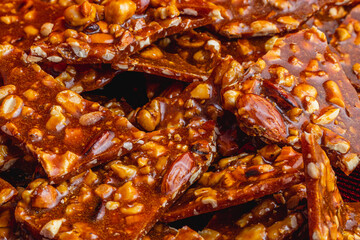 Homemade sugar cookies with nuts on a shiny red plate close up