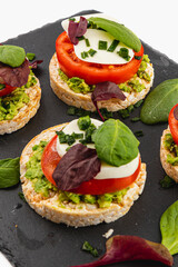 Healthy eating concept, rice cakes with avocado, mozzarella, spinach and onion