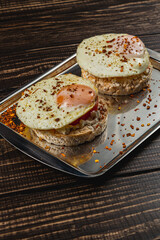egg sandwiches on rice bread with tomato and cheese on a metal plate