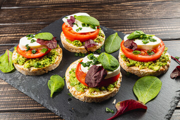 Healthy eating concept, rice cakes with avocado, mozzarella, spinach and onion