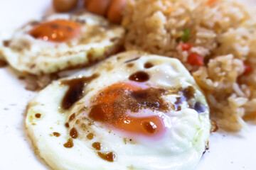 Closeup side view of fried egg with soy and pepper.