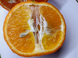 a piece of tangerine, orange on a white background. In section