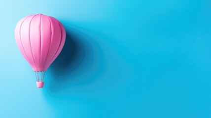 Obraz premium Pink hot air balloon floating against blue sky background