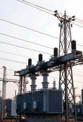 High voltage electrical transformer substation. Power station. Power line, close-up, with white tones