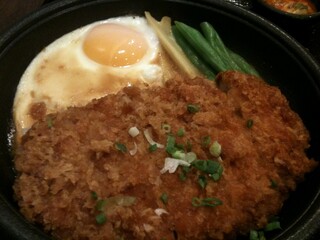 Katsudon bowl with sunny side up egg  and onions over rice, Japanese food, hearty comfort food