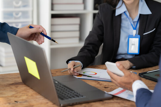 Strategic Collaboration: A focused business meeting unfolds as colleagues analyze data, brainstorm ideas, and plan for success. This image captures the essence of teamwork, communication.
