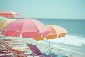 Wooden deck chairs on sandy beach near sea. Holiday background.