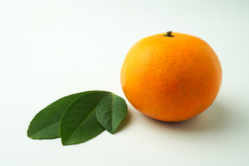 Ripe tangerines and Green orange leaves isolated on white background. Concept for Chinese Lunar New Year.
