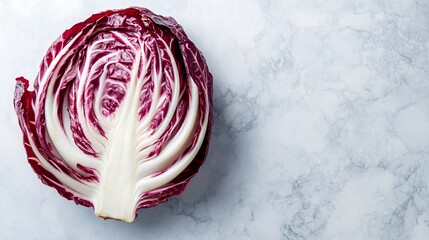 Fototapeta premium A top-down view of a sliced radicchio, isolated on a soft grey marble background with soft edges