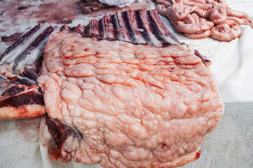 Meat on the counter at the market. An assortment of raw meat with fat.
